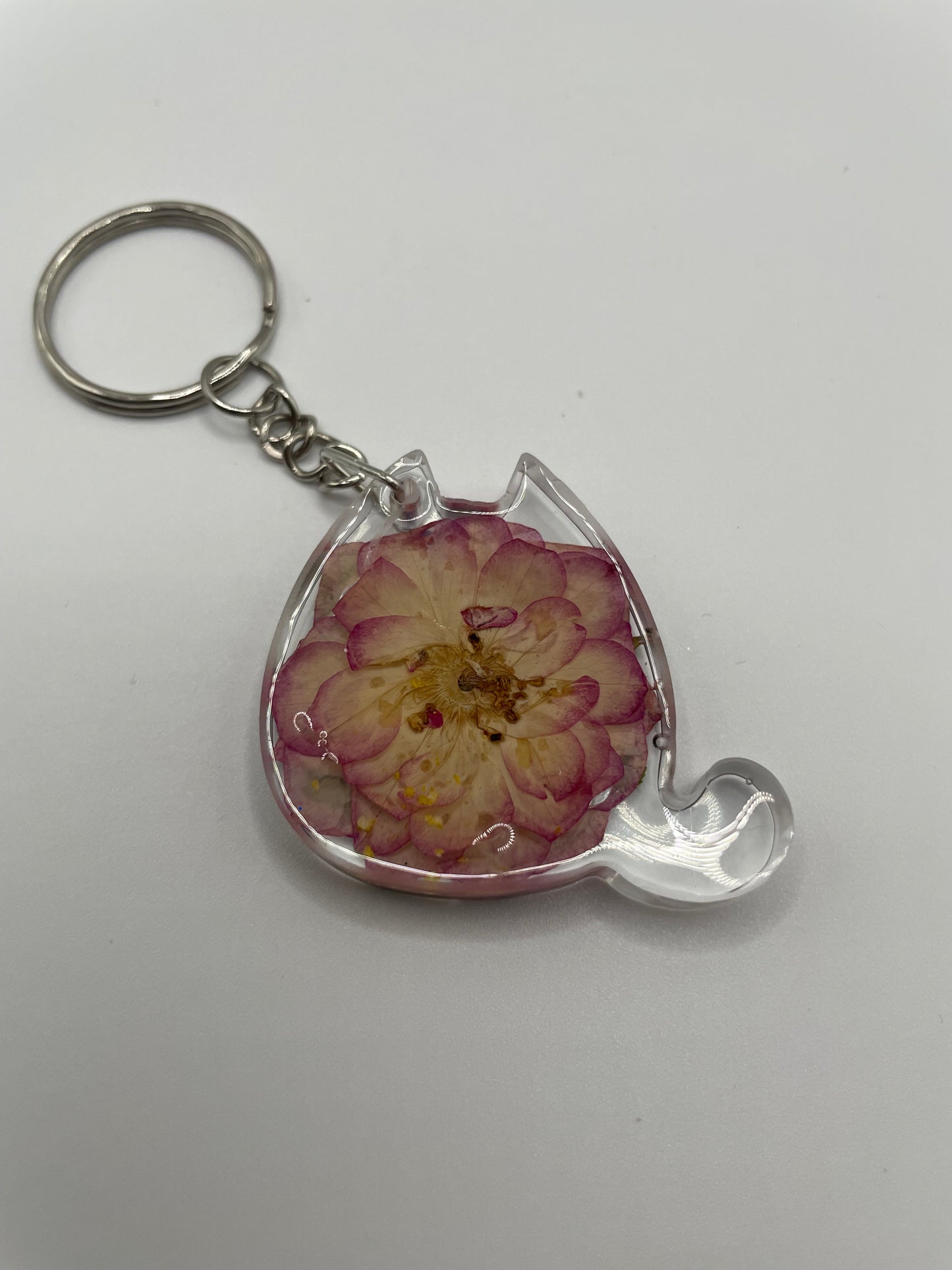 Keychain with a pink flower design on a white background
