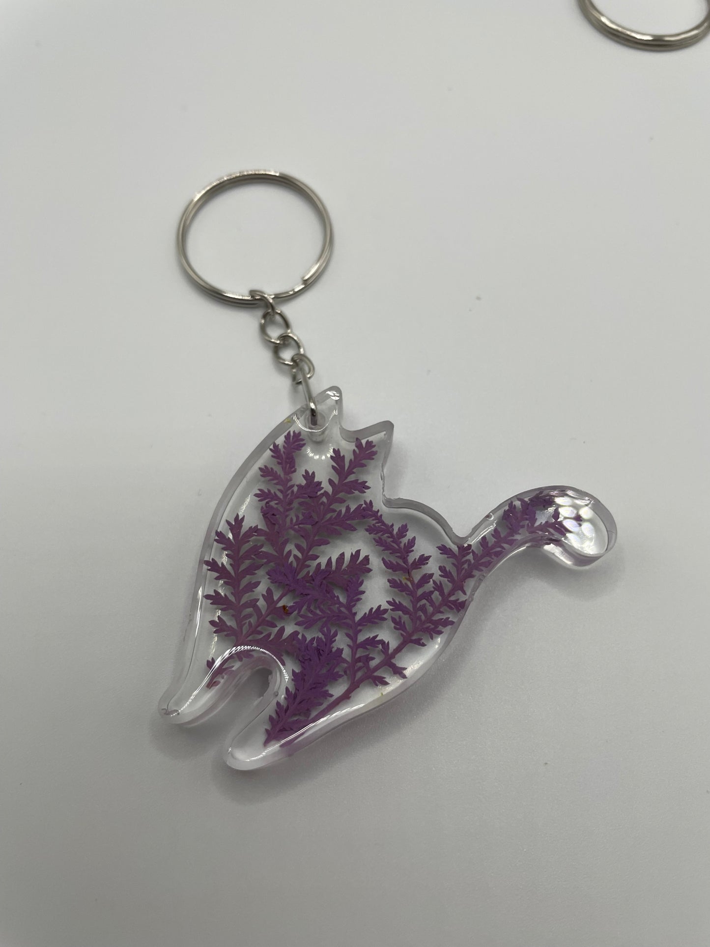 Keychain with purple floral design on a white background