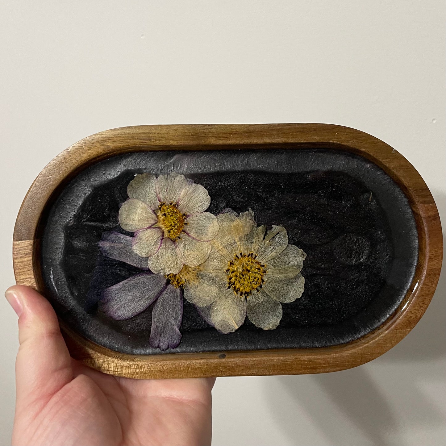 dried flowers on small oval wooden tray