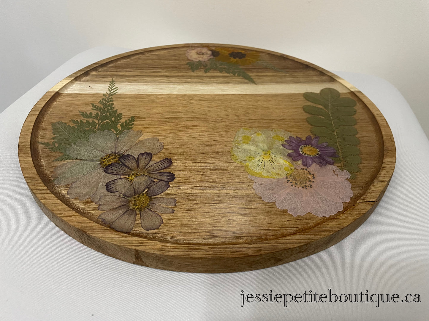 dried flowers on a round wooden tray
