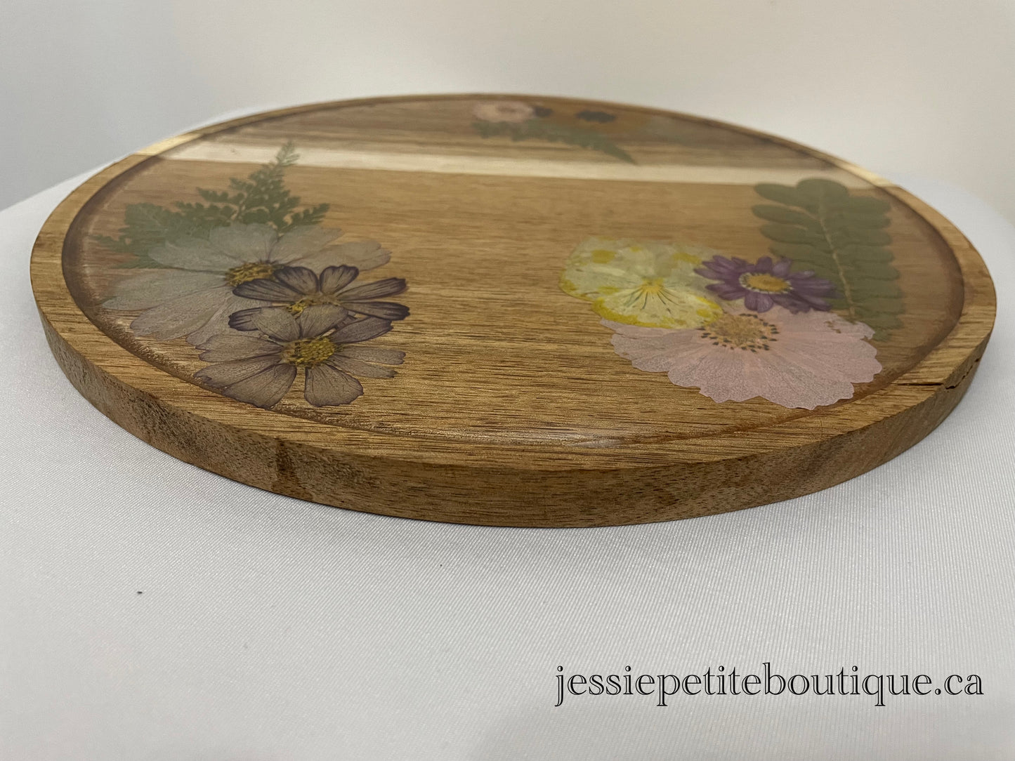 dried flowers on a round wooden tray