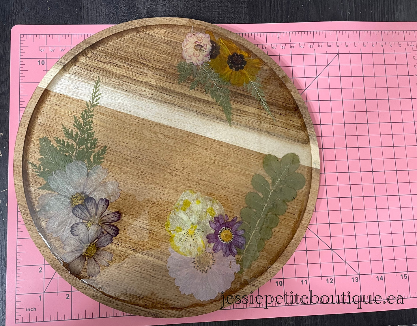 dried flowers on a round wooden tray