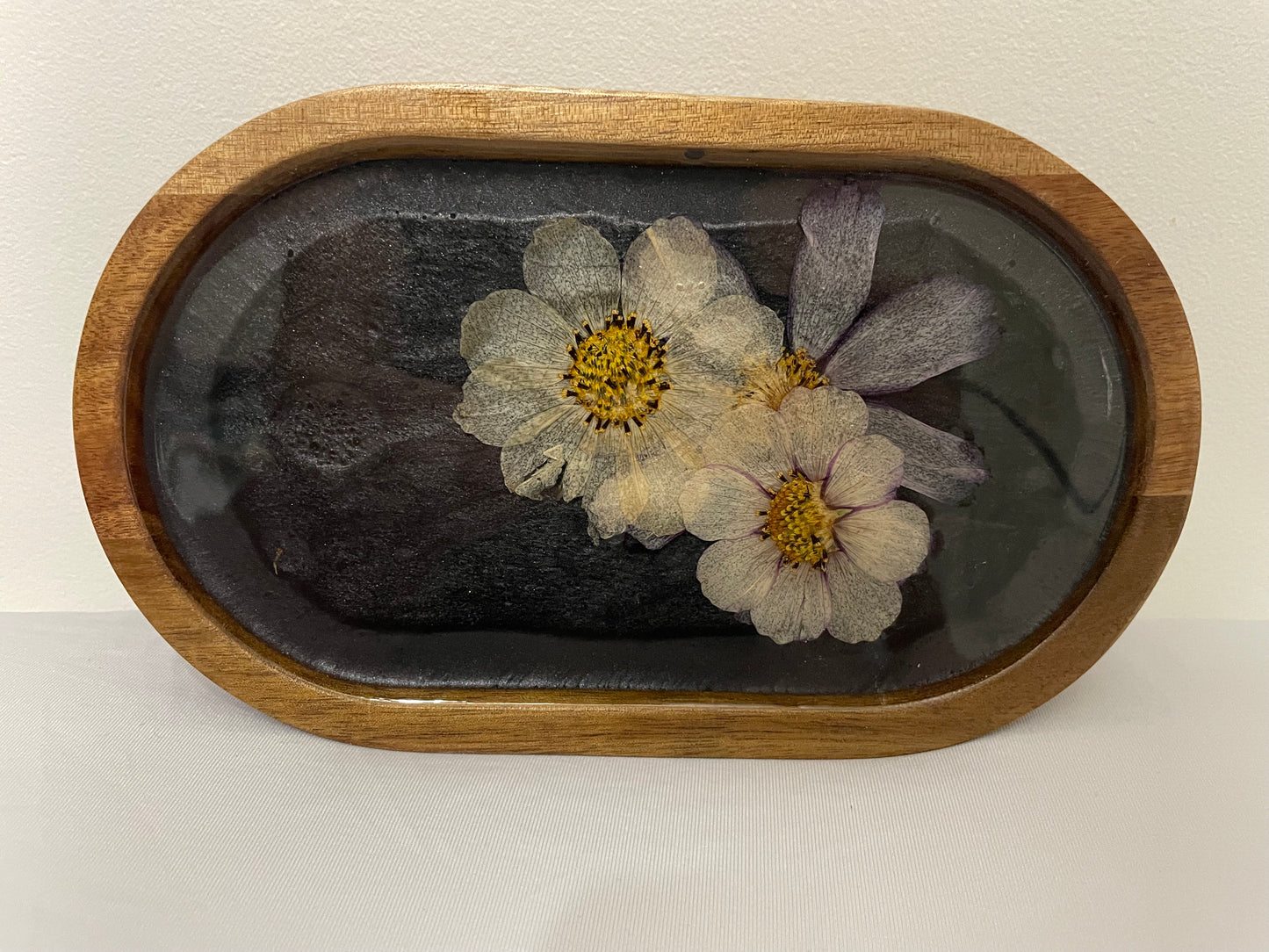 dried flowers on small oval wooden tray