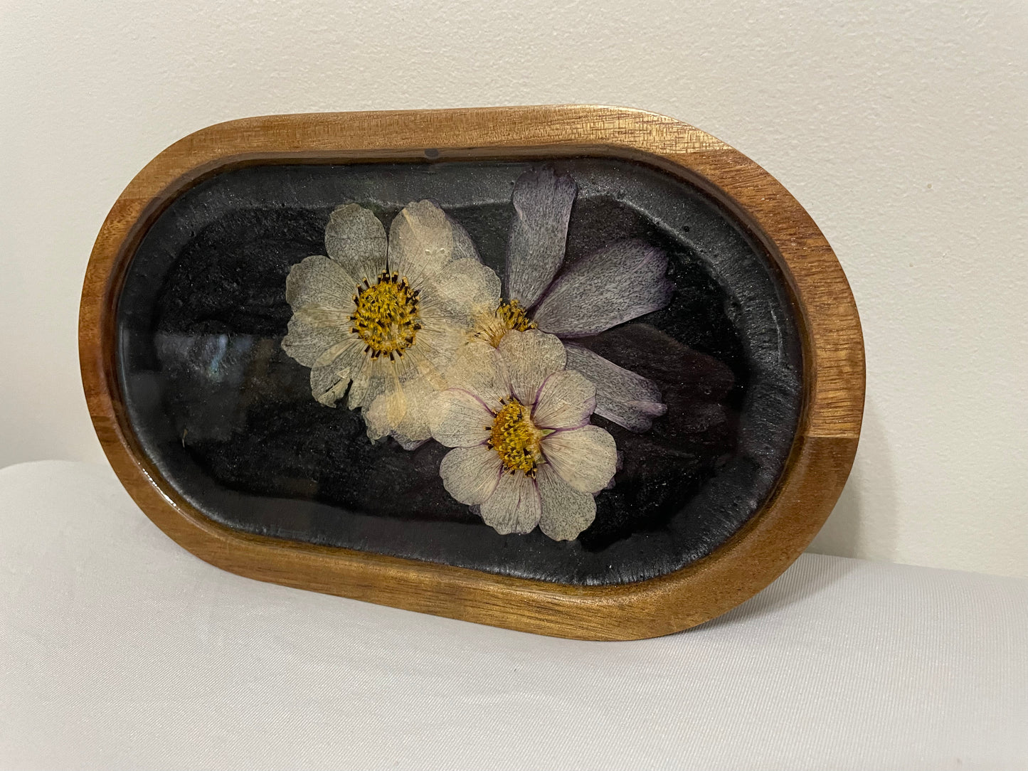 dried flowers on small oval wooden tray