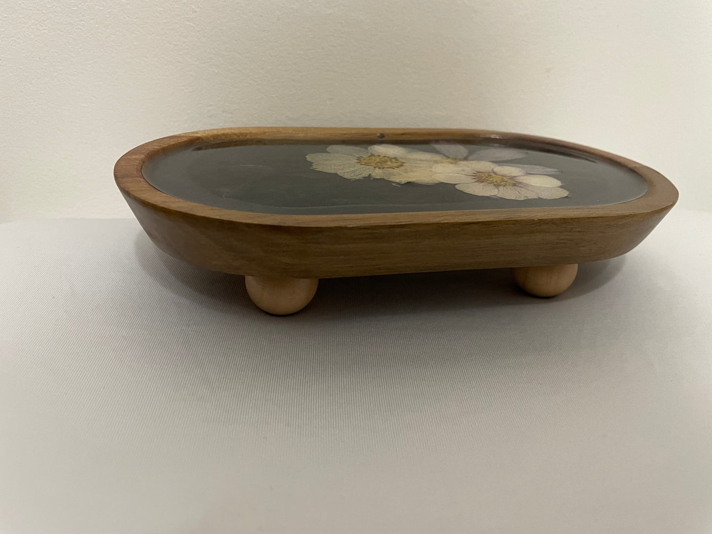 dried flowers on small oval wooden tray