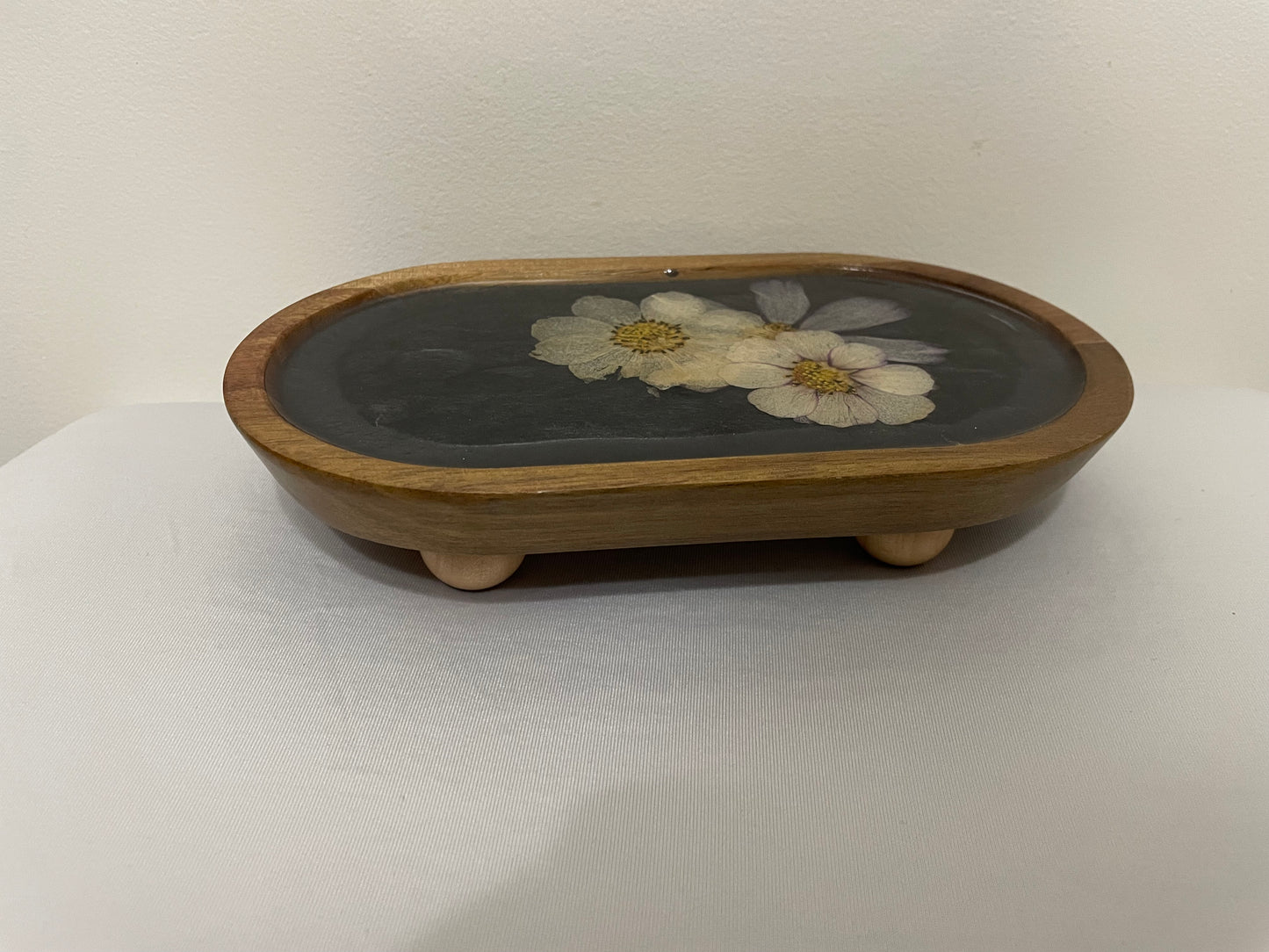 dried flowers on small oval wooden tray