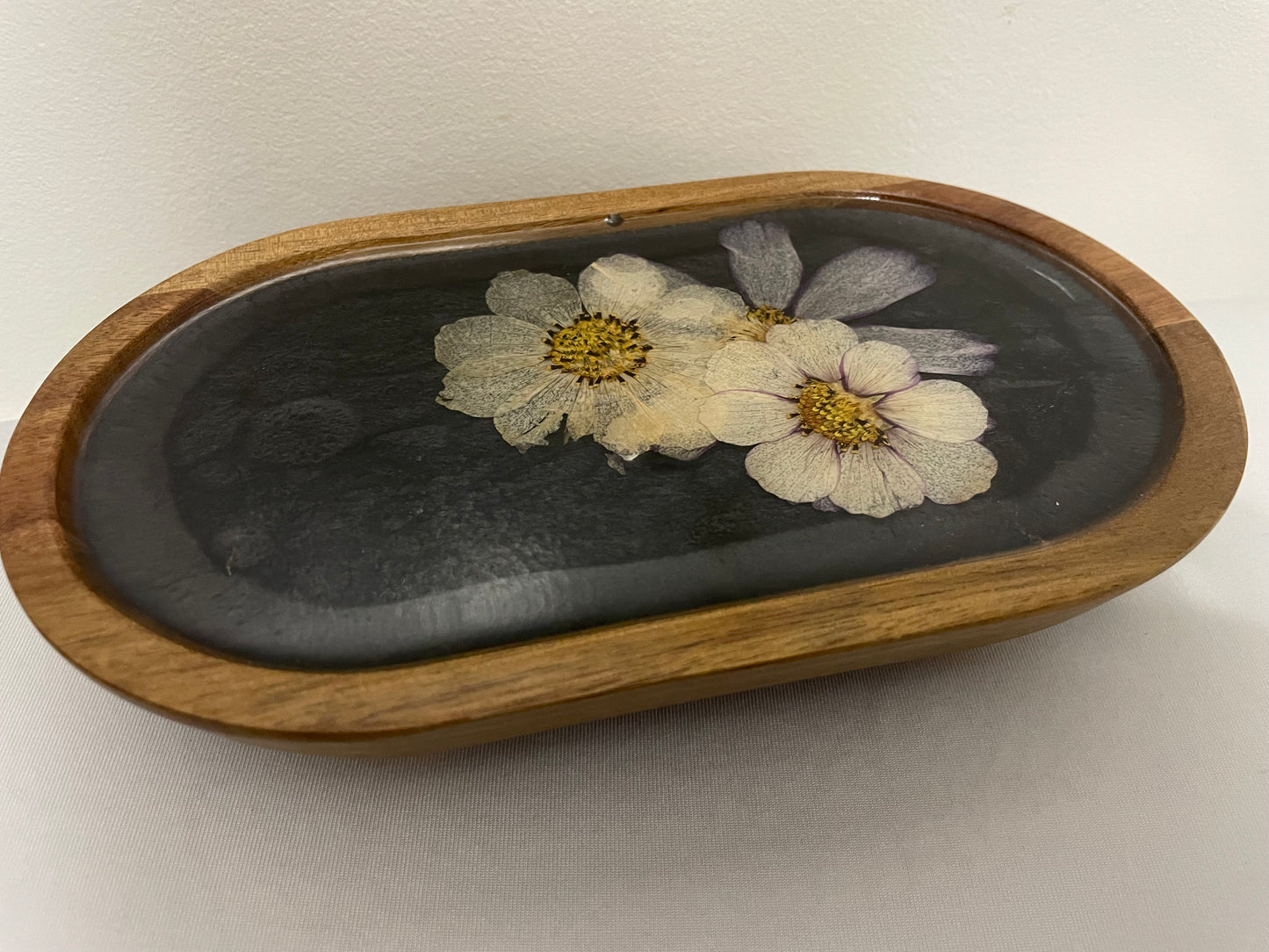 dried flowers on small oval wooden tray