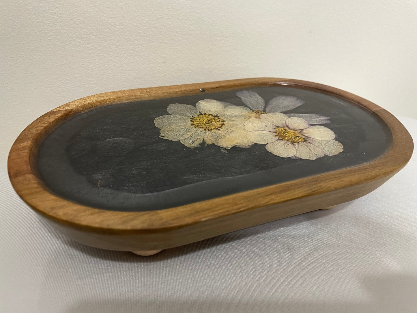 dried flowers on small oval wooden tray
