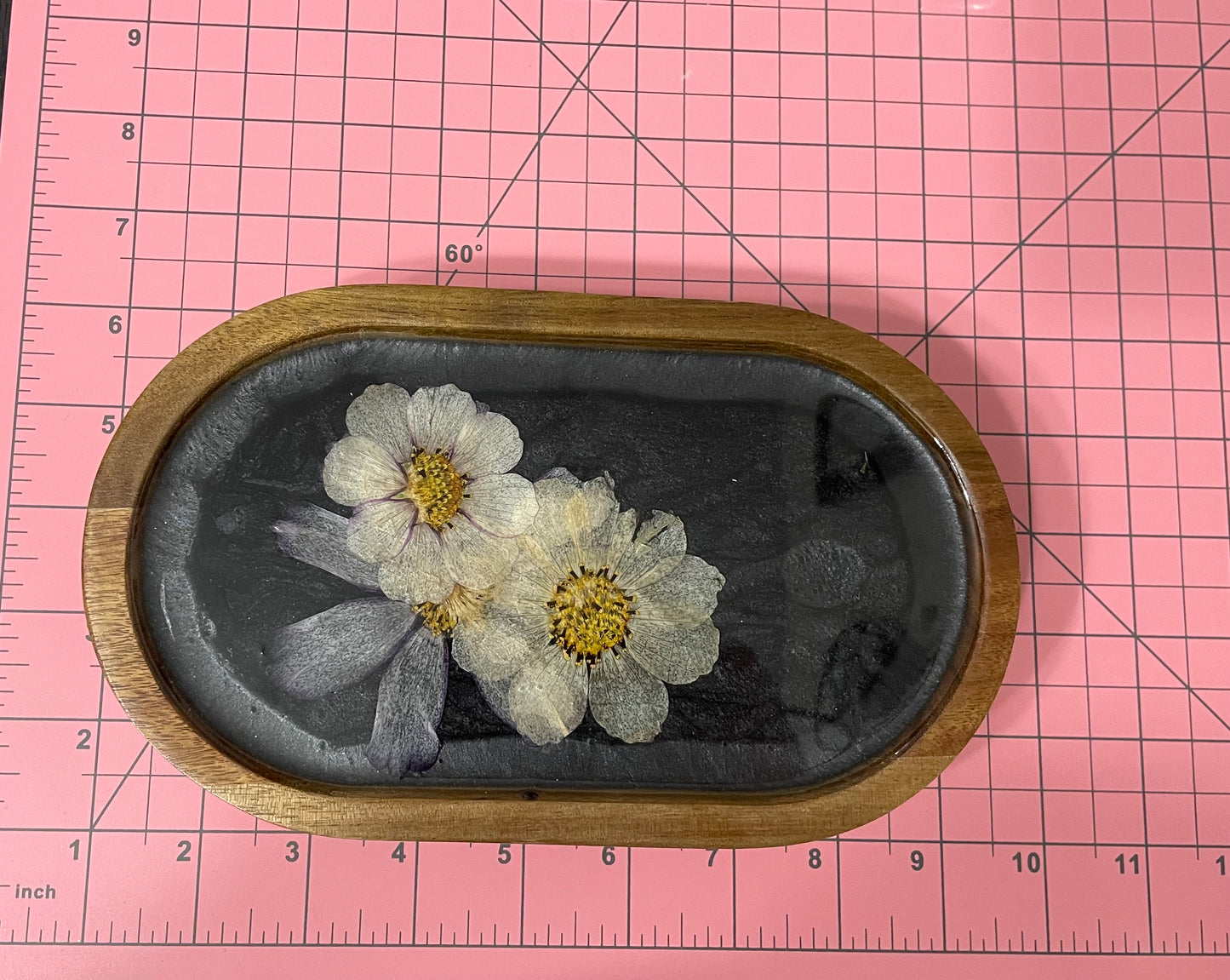 dried flowers on small oval wooden tray