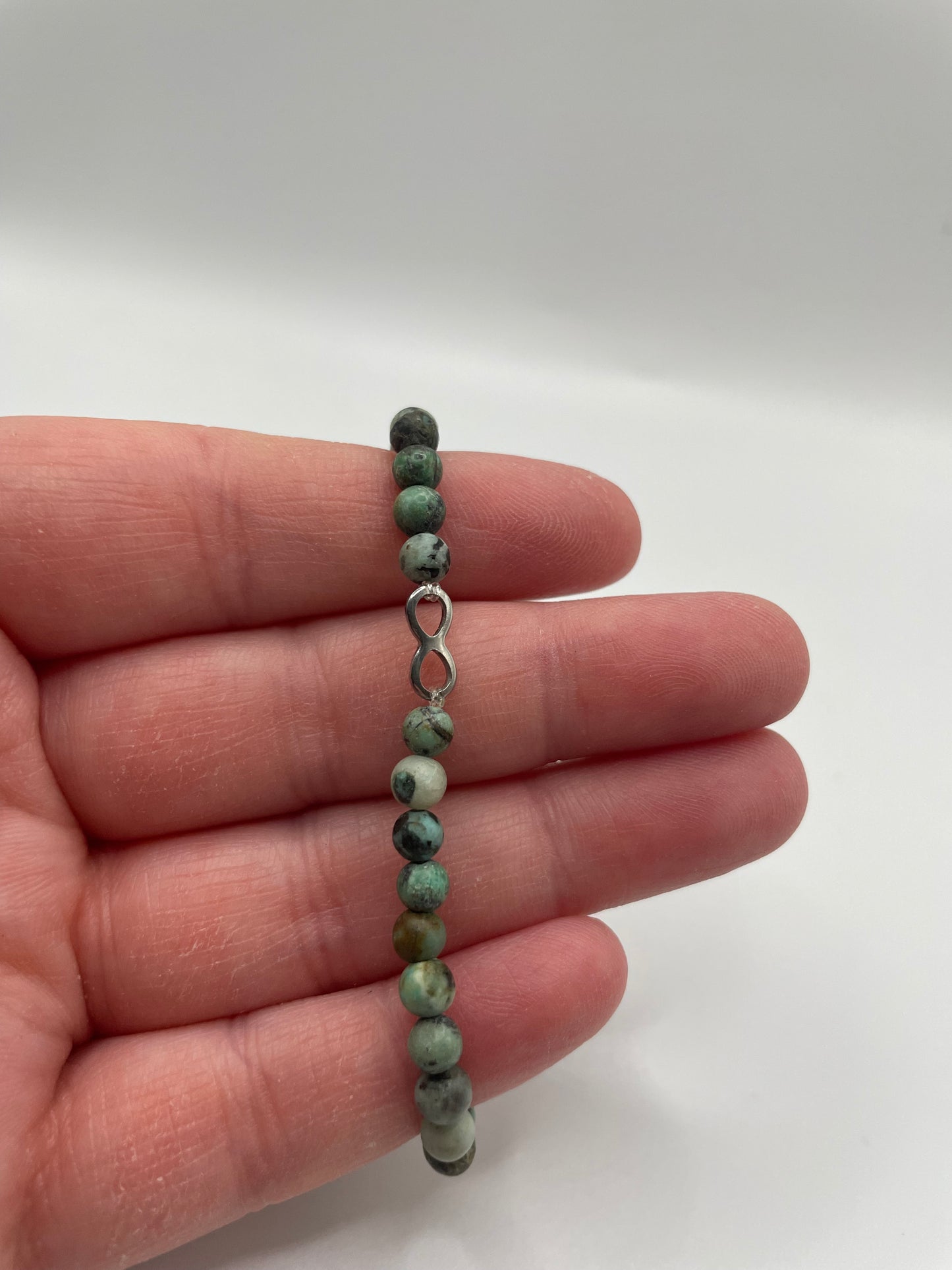 Green Beaded Bracelet with Infinity Charm