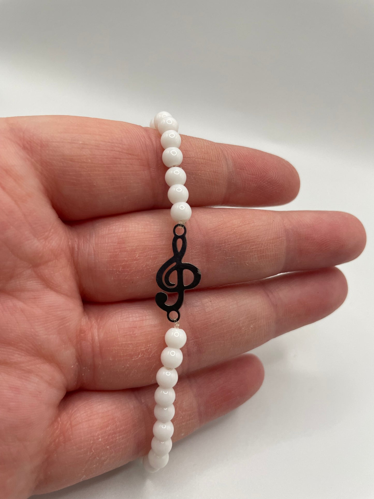 White Beaded Bracelet with Treble Clef Charm