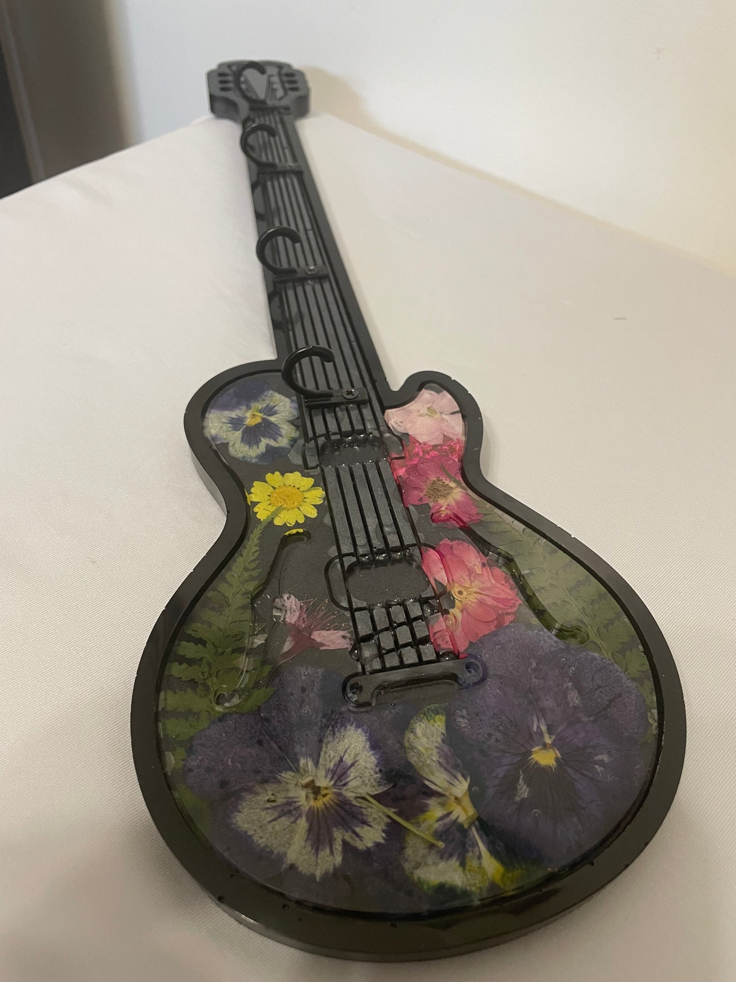 Decorative guitar with floral patterns on a white background