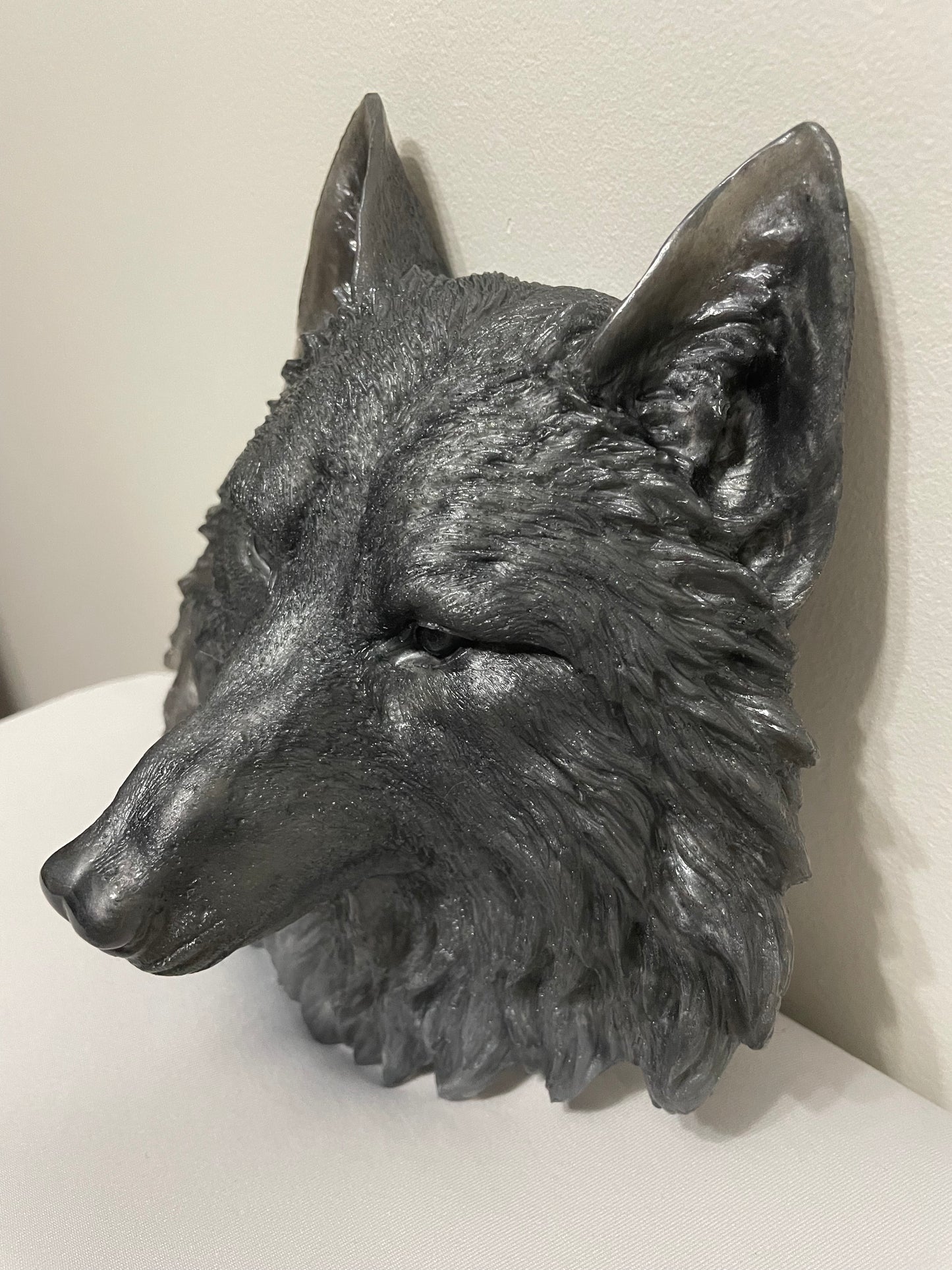 Decorative wolf head sculpture on a white background
