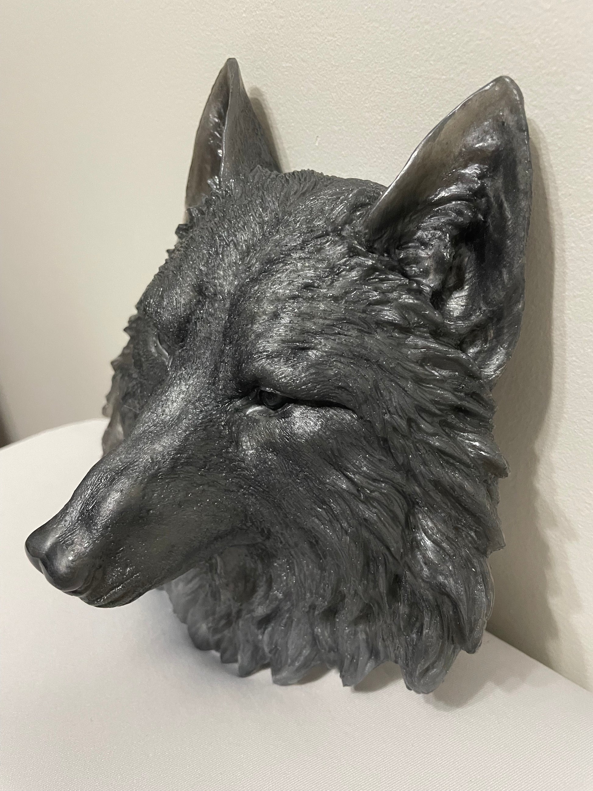 Decorative wolf head sculpture on a white background