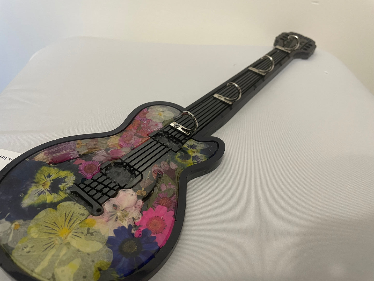 Floral-patterned guitar on a white surface