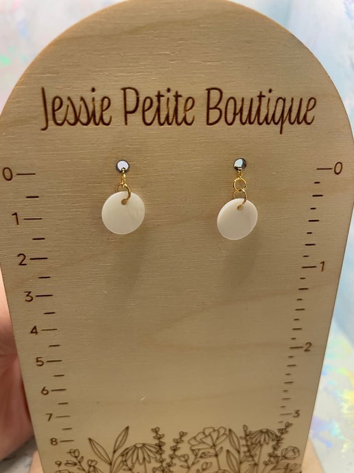 Pair of round earrings on a wooden display card with 'Jessie Petite Boutique' branding.