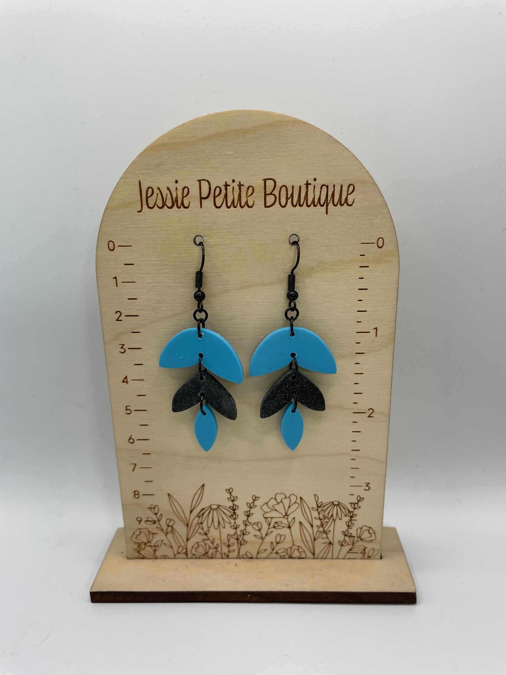 A-Alba: Black & Blue Earrings  on a wooden display card with 'Jessie Petite Boutique' branding.