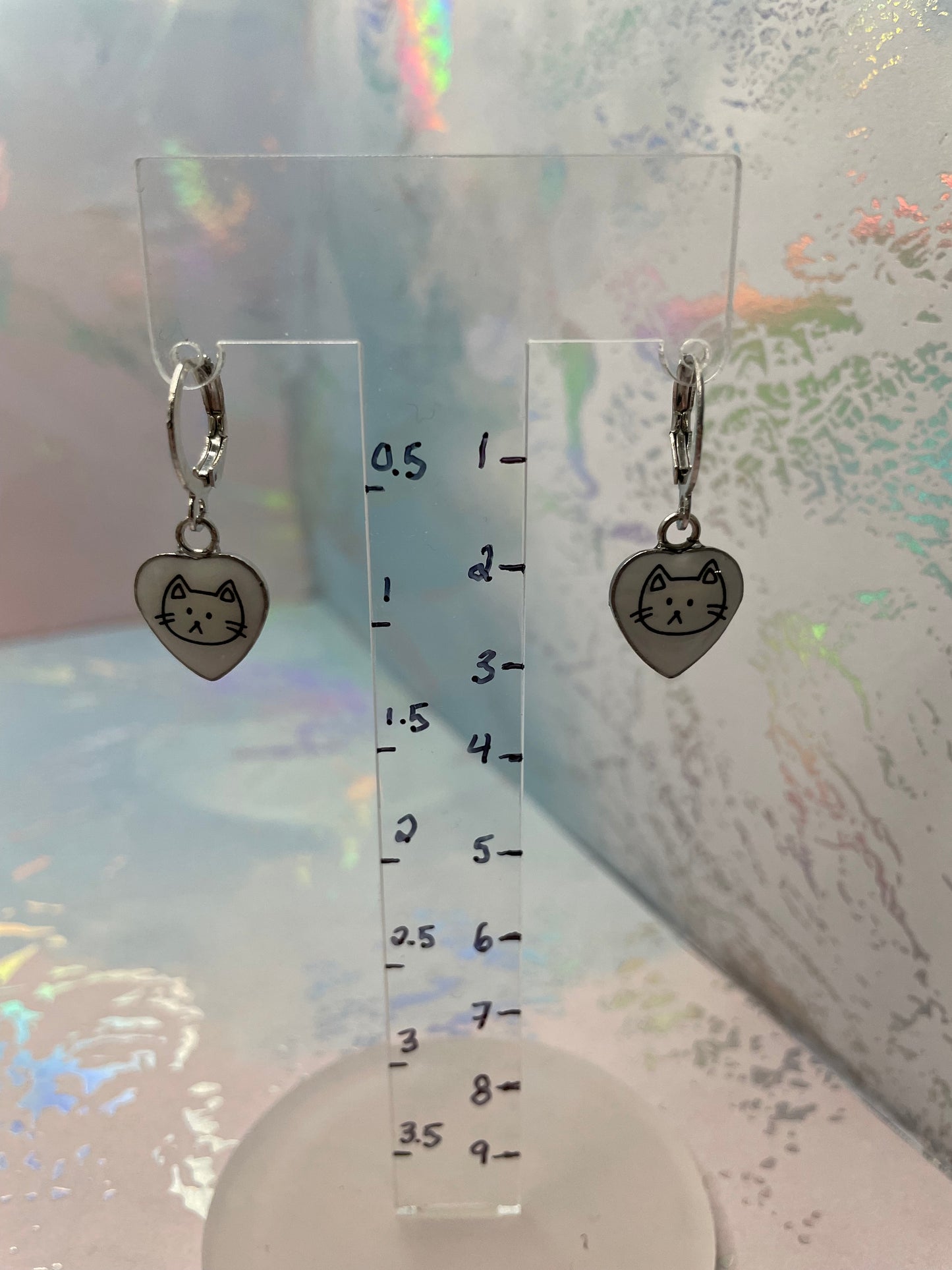 Small key-shaped charm with a heart design on a clear ruler background