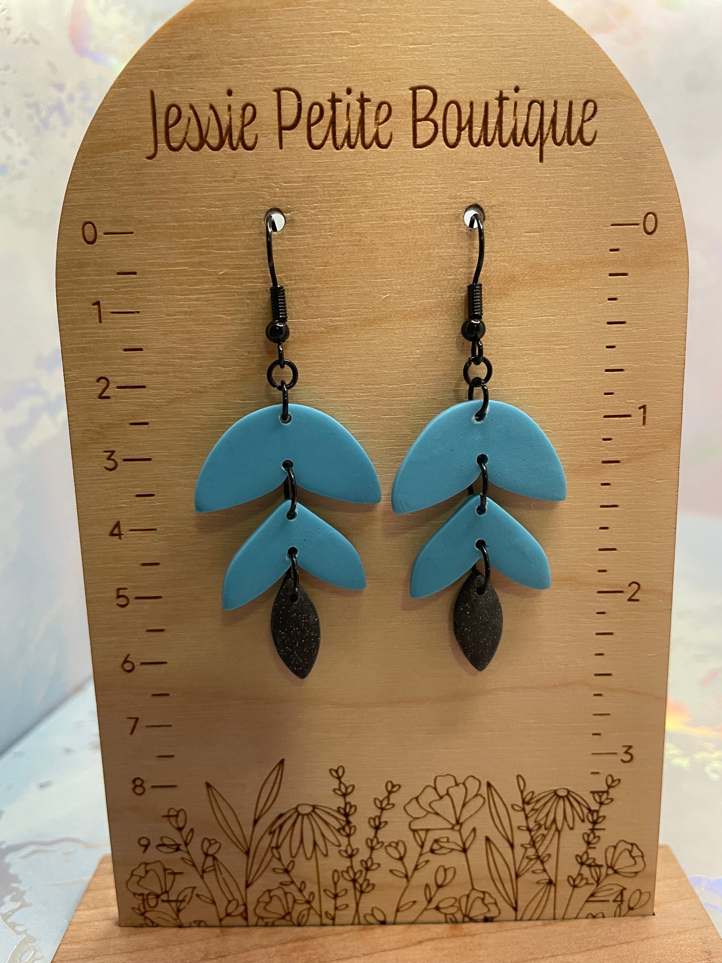 Blue Alba earrings on a wooden display card with measurements and 'Jessie Petite Boutique' branding.
