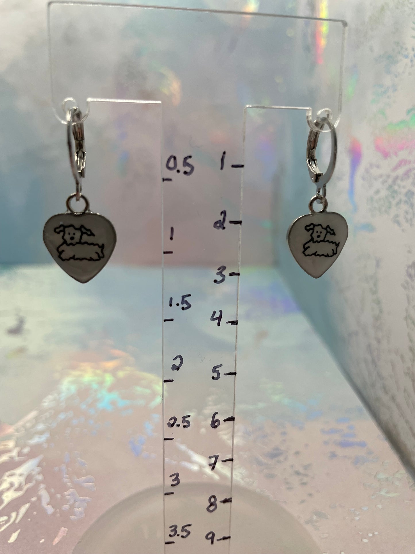 Cute Puppy Heart Dangle Earrings on a clear ruler background