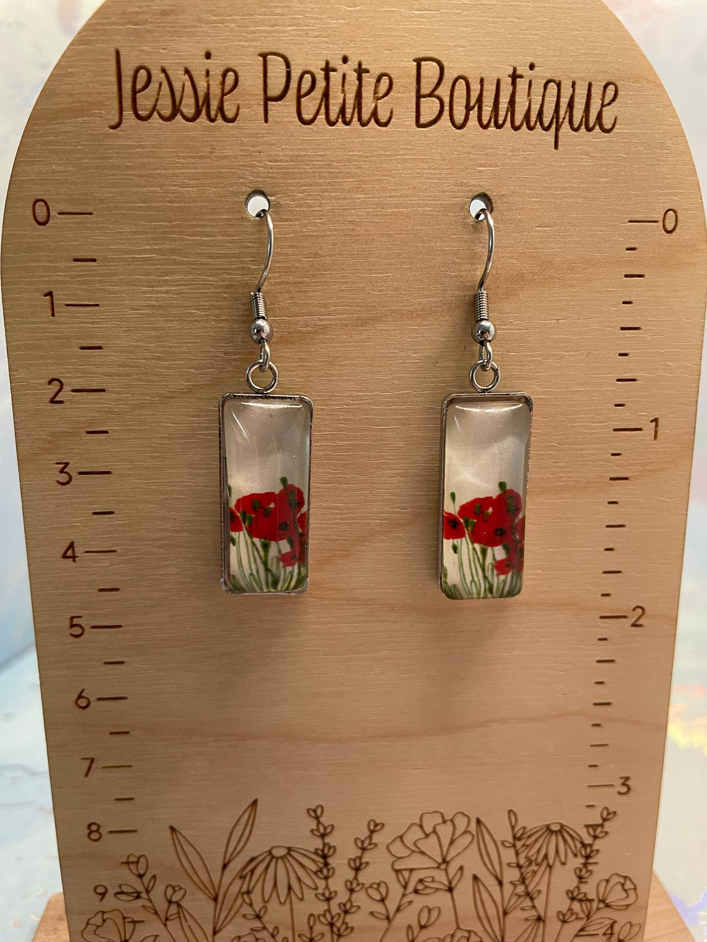 Pair of earrings with floral design on a wooden ruler from Jessie Petite Boutique