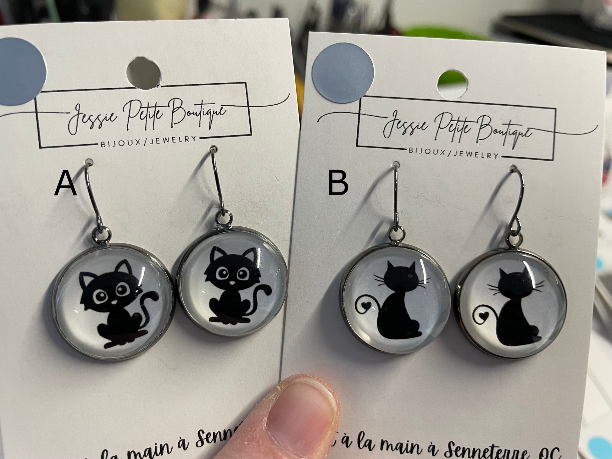 Two pairs of earrings with cat designs on cards from Jessie Petite Boutique.