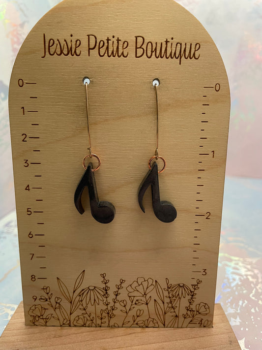 Wooden earring display card with earrings and measurement scale, branded 'Jessie Petite Boutique'.