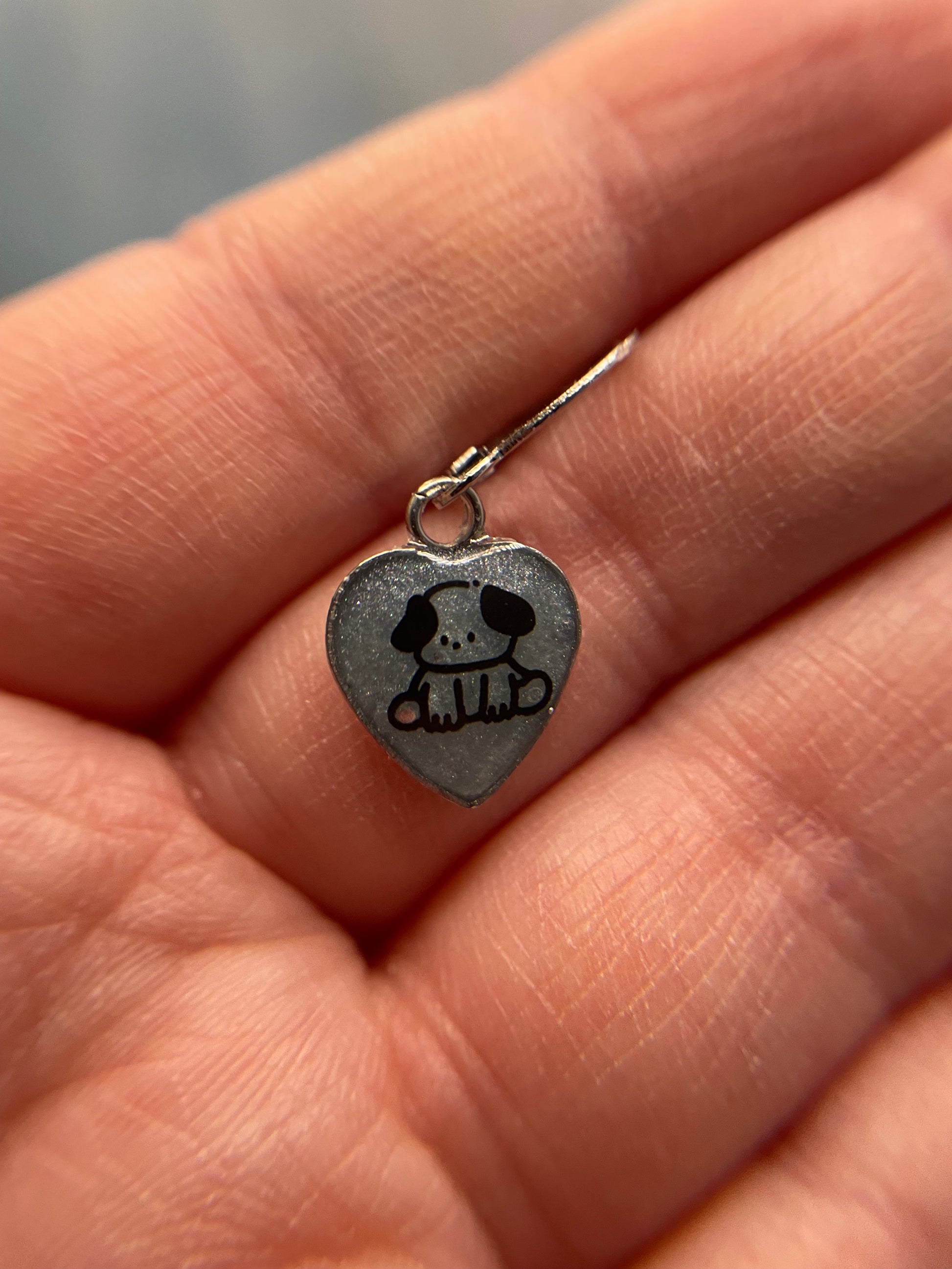 Cute Cat/Puppy Heart Dangle Earrings held between fingers