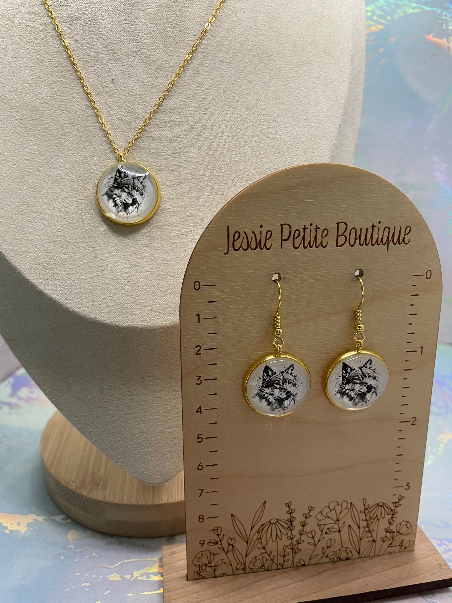 Jewelry set with earrings and a necklace on a wooden display card from Jessie Petite Boutique.