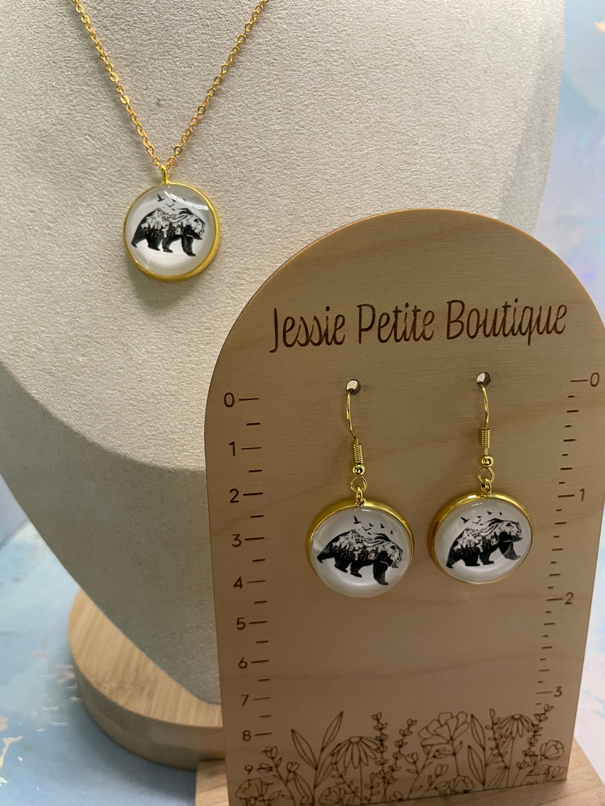 Jewelry set with earrings and necklace on a 'Jessie Petite Boutique' card.