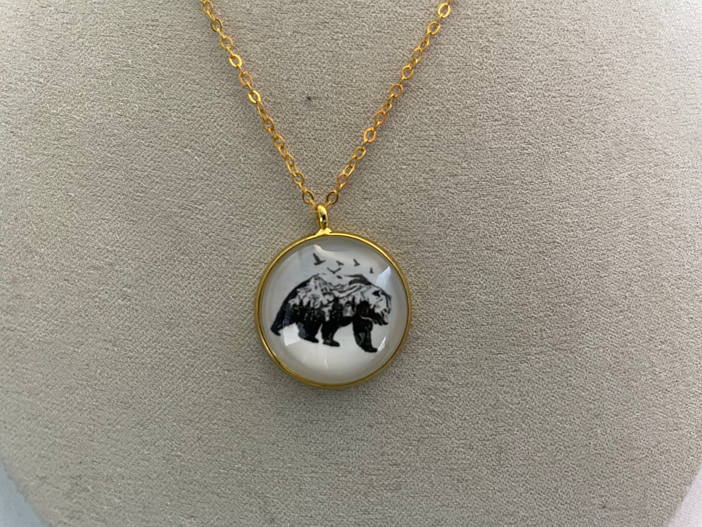 Necklace with a bear pendant on a light gray background