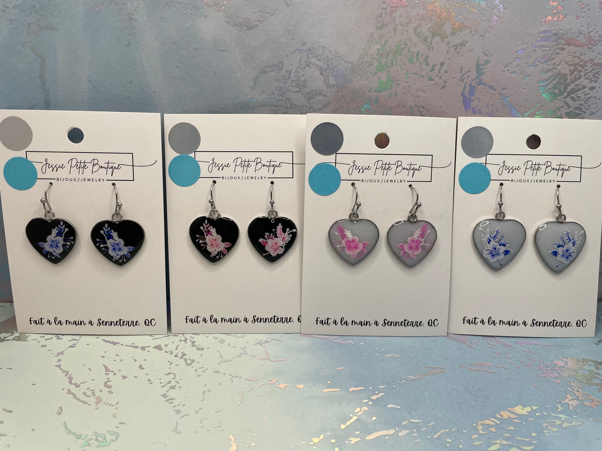 Set of heart-shaped earrings on display cards with 'Jesse Petite Boutique' branding.