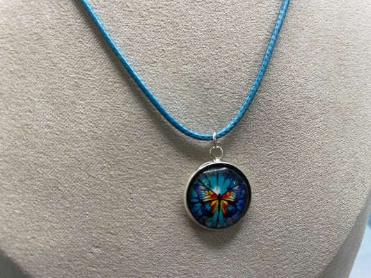 Collier cabochon papillon – corde bleu