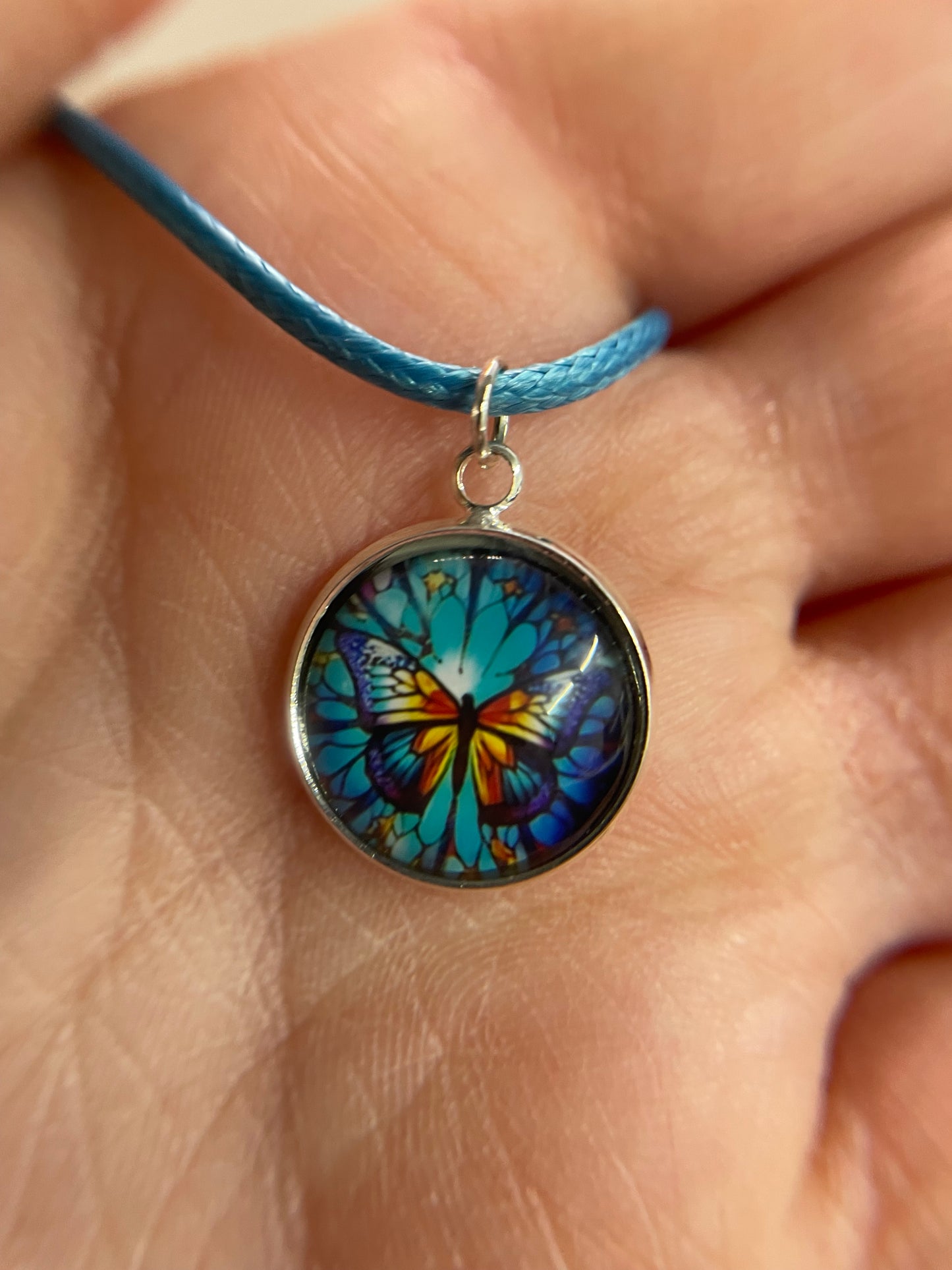 Collier cabochon papillon – corde bleu