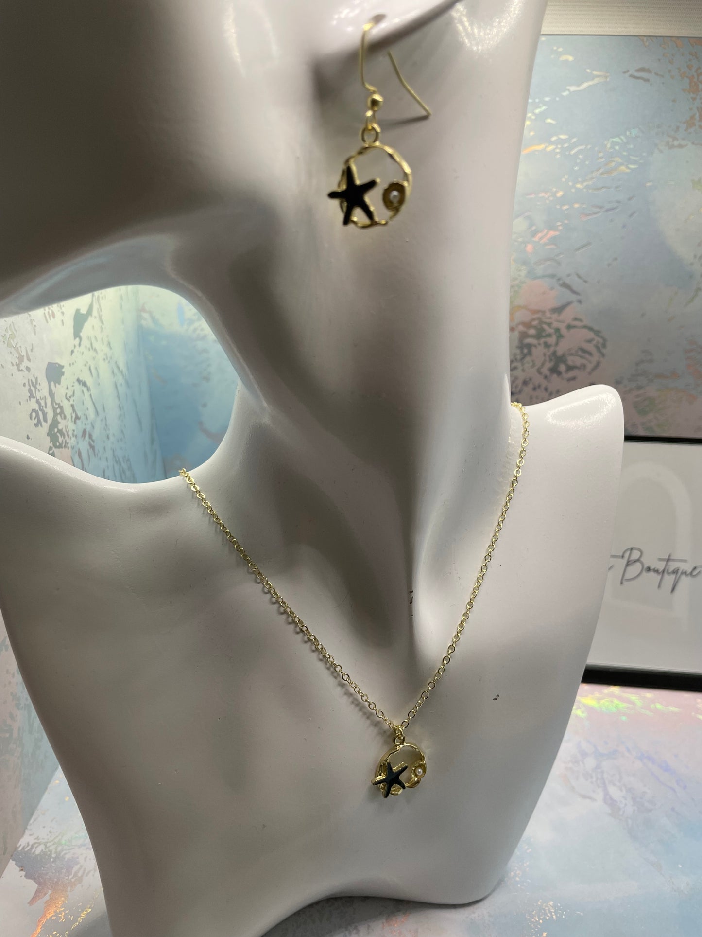 Étoile de mer noire sur cercle doré avec perles 