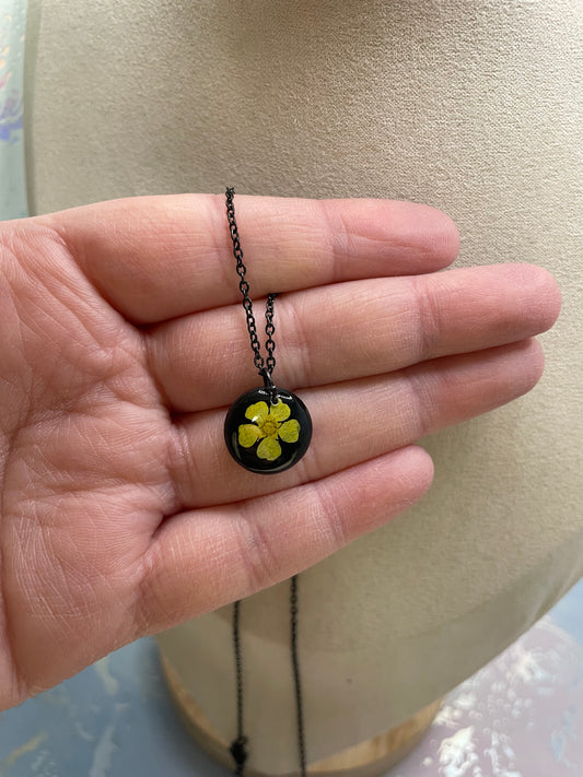 Collier petit rond fleur bouton-d’or jaune sur fond noir