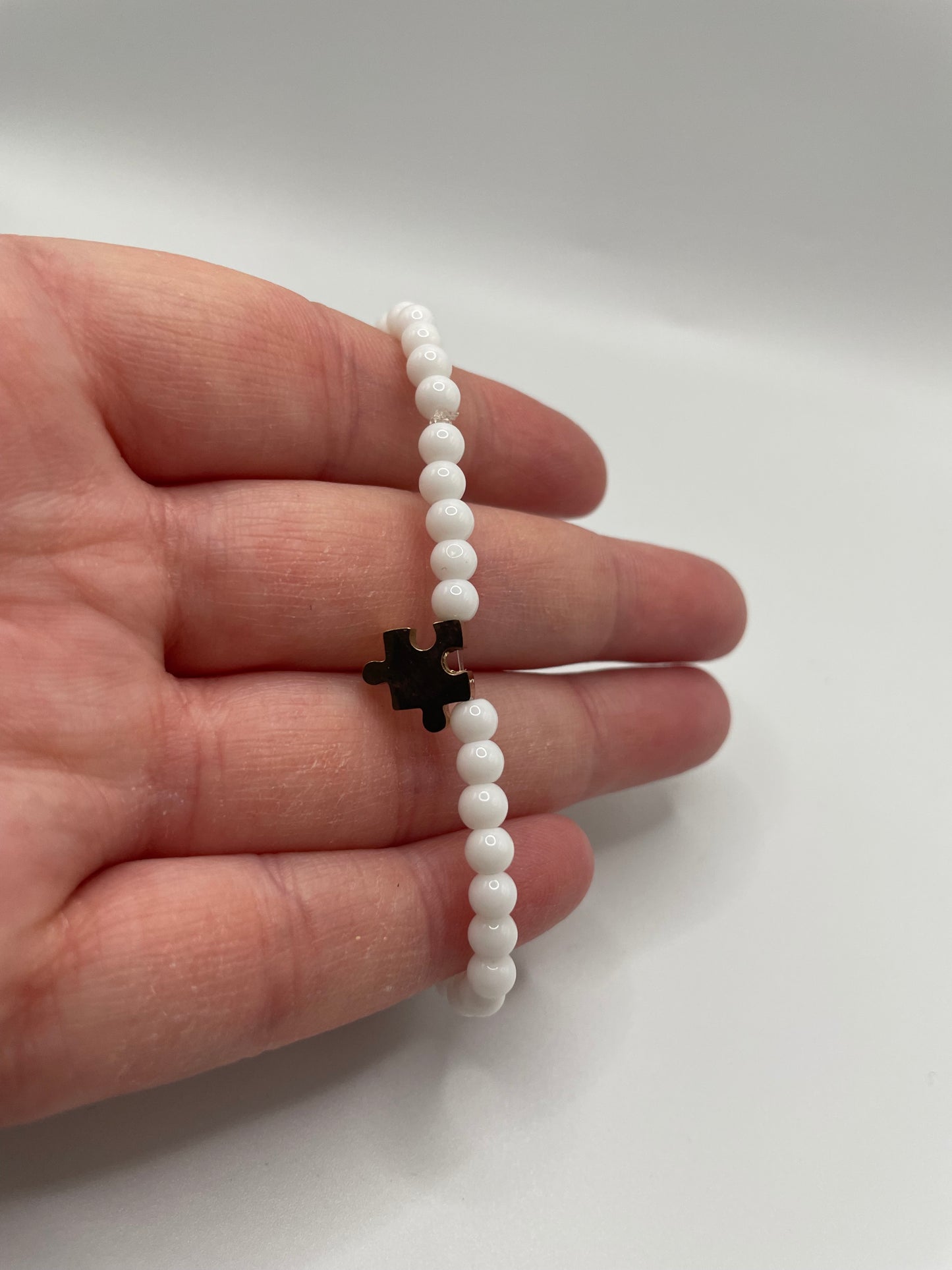 White Beaded Bracelet with Rose Gold Puzzle Charm