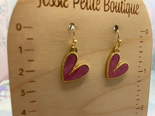 Heart-shaped earrings on a wooden measuring card with 'Jessie Petite Boutique' branding.