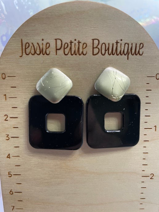 Pair of earrings on a wooden display card with 'Jessie Petite Boutique' branding.
