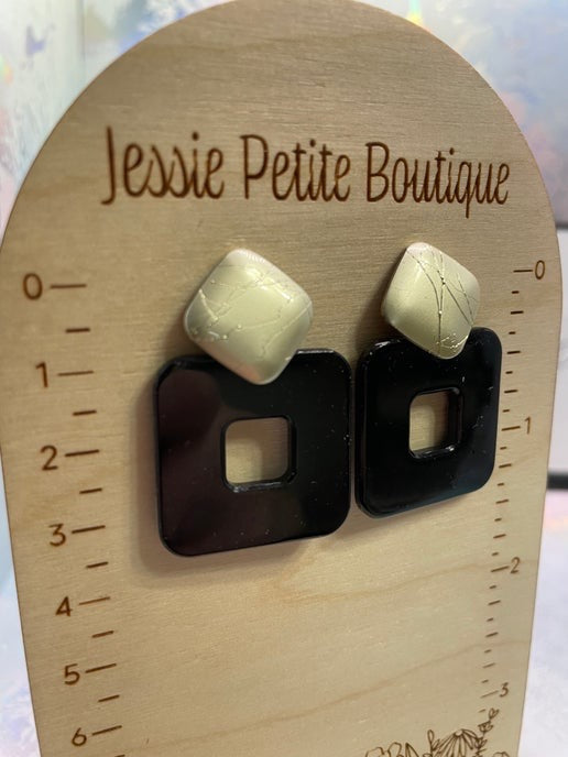 Pair of earrings on a wooden display card with 'Jessie Petite Boutique' branding.