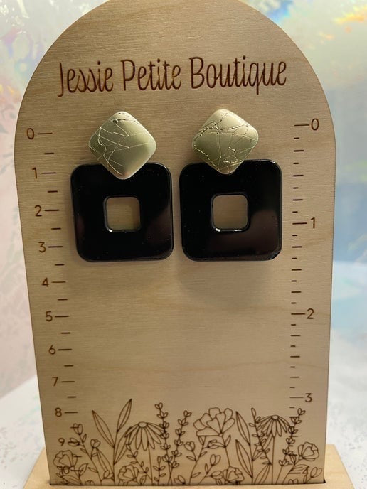 Pair of earrings on a wooden display card with 'Jessie Petite Boutique' branding.