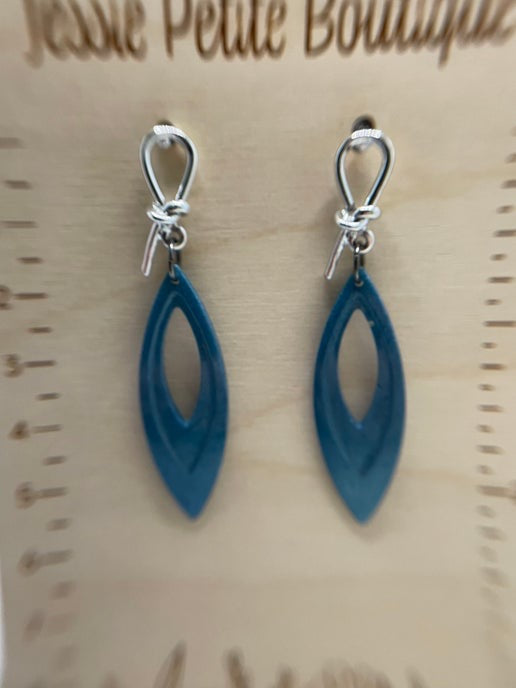 Blue earrings on a wooden display card with 'Jessie Petite Boutique' branding.