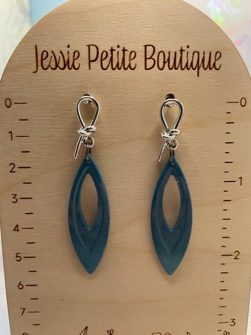 blue earrings on a wooden display card with 'Jessie Petite Boutique' branding.