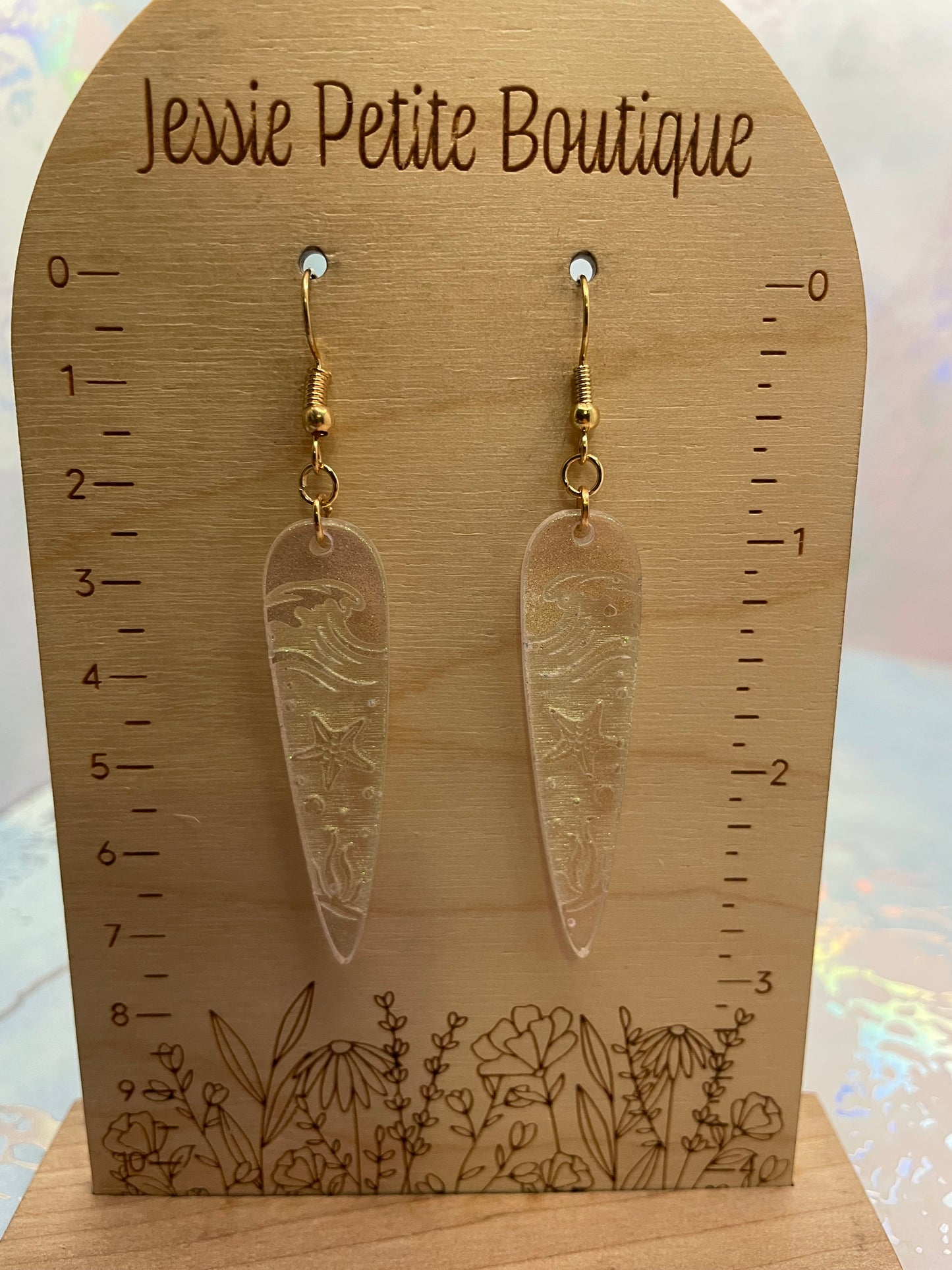chameleon olive Ocean Wave Engraving: Earrings on a wooden card with measurements and 'Jessie Petite Boutique' branding.