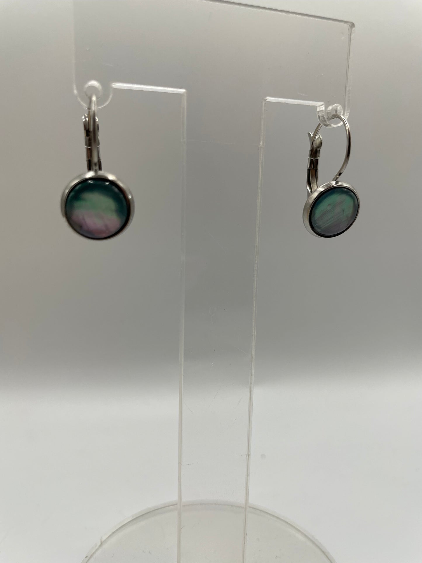 Shell Cabochon Leverback Earrings on a clear stand against a white background