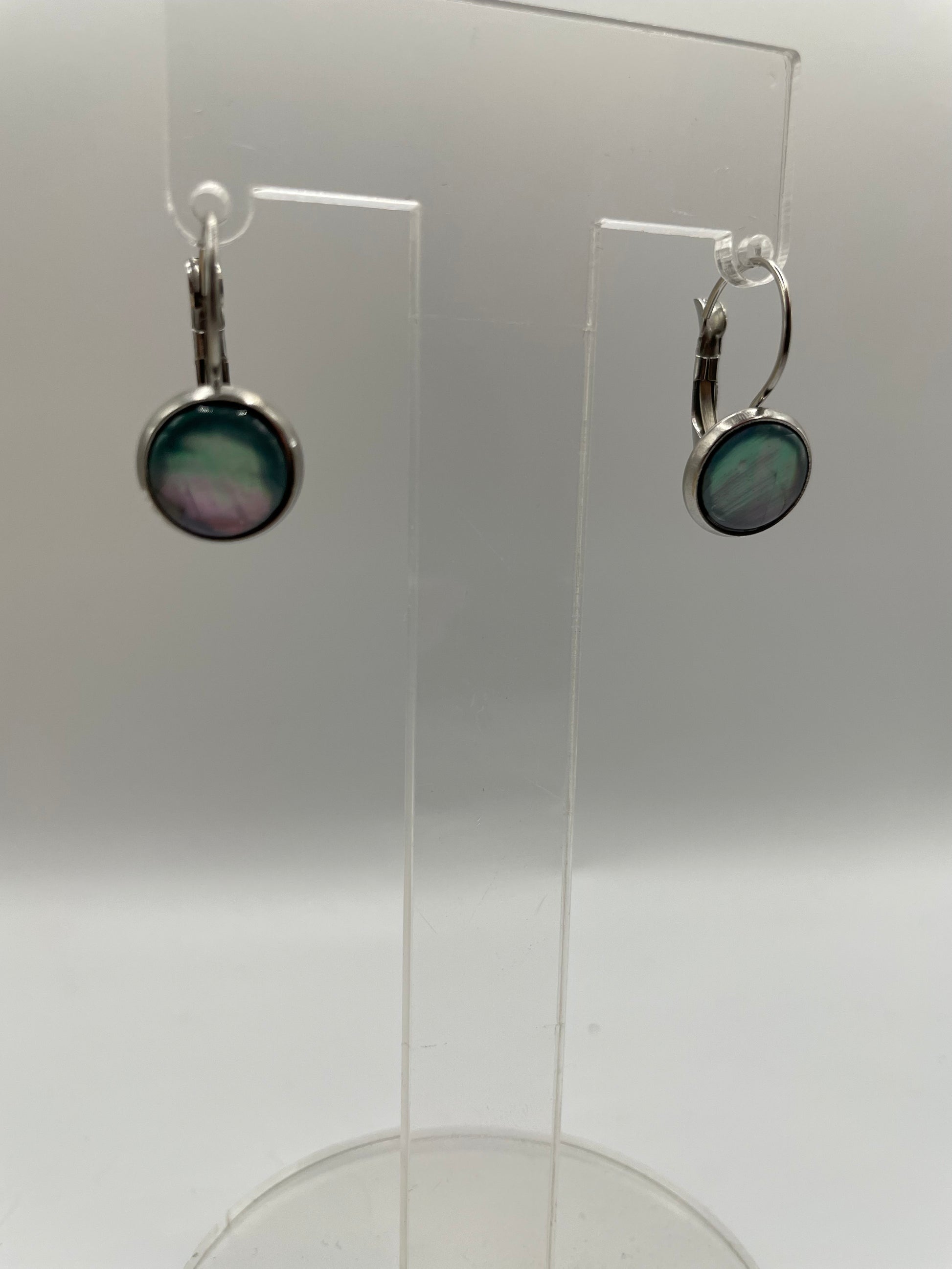 Shell Cabochon Leverback Earrings on a clear stand against a white background
