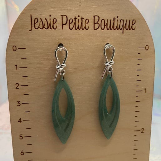 Green earrings on a wooden display card with 'Jessie Petite Boutique' branding.