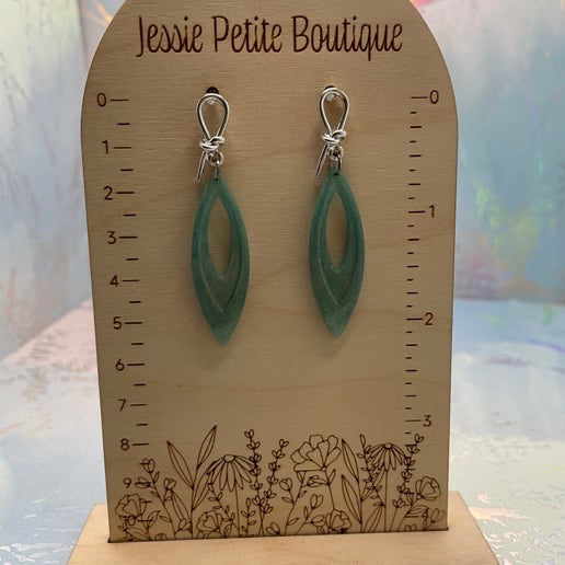 Green earrings on a wooden display card with 'Jessie Petite Boutique' branding.