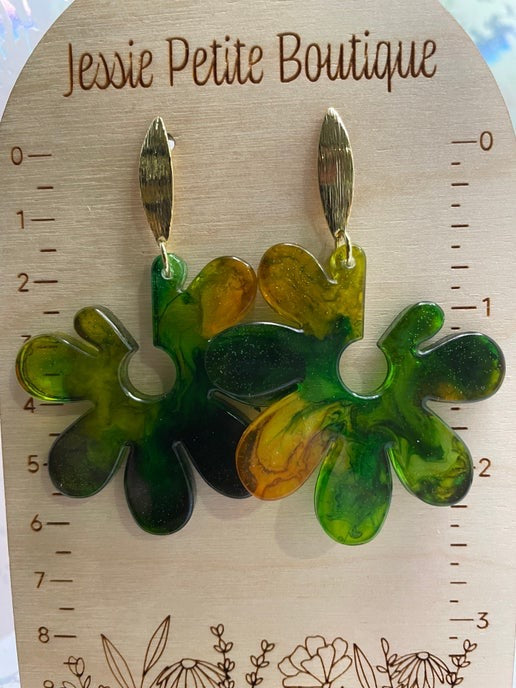 Green and gold floral earrings on a wooden card with 'Jessie Petite Boutique' branding.