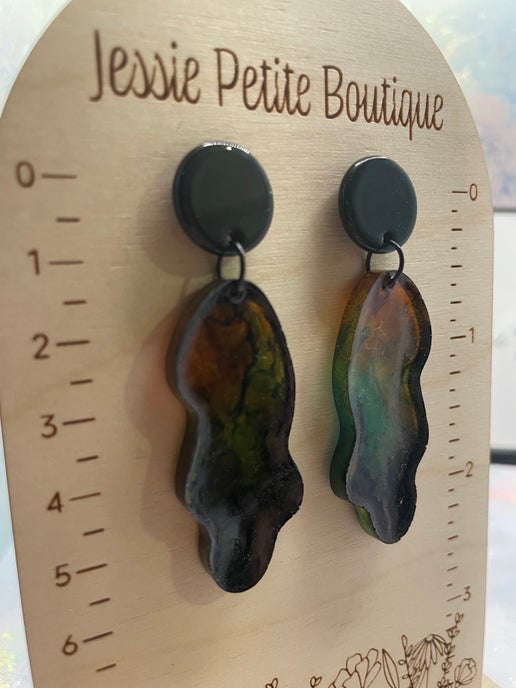 Pair of earrings on a wooden display card with 'Jessie Petite Boutique' branding.